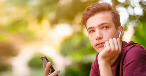 young man with phone and earbuds