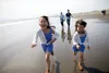 girls running on beach