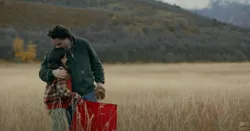A father and daughter fly a kite together