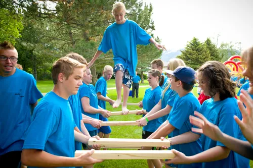 a group of youth line up and do a trust activity