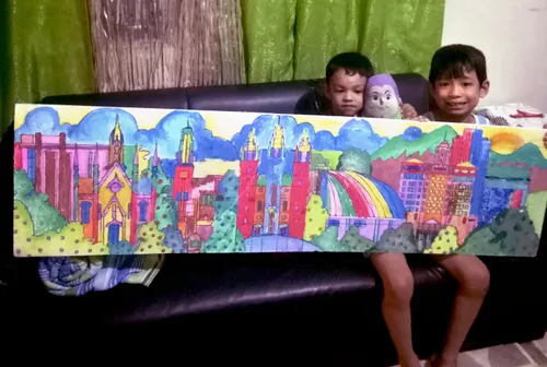 Two children holding a colorful illustration of Temple Square