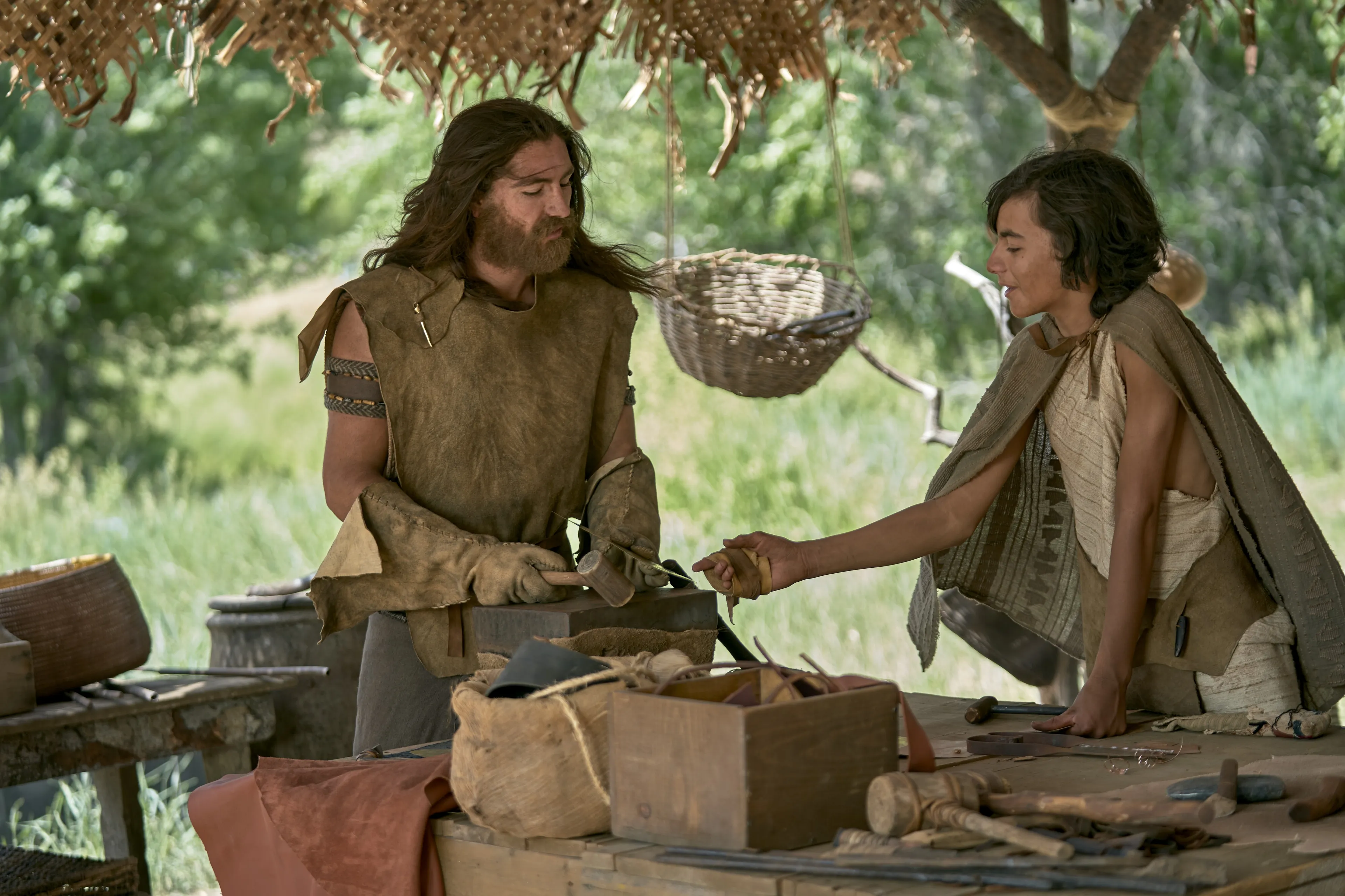 A young Jacob is outside creating plates with Nephi.