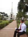 youth reading scriptures near temple