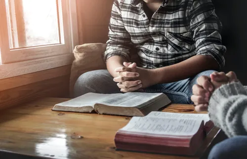 A couple sitting and praying together