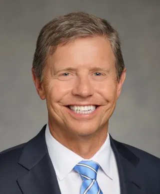 S. Mark Palmer takes an official portrait in 2022.