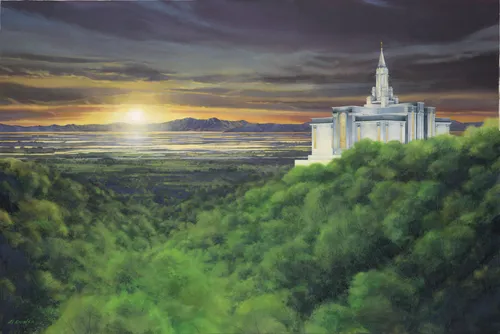 the Bountiful Utah Temple on a tree covered hill at sunset