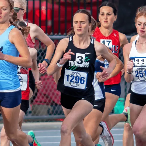 young woman running in a track meet