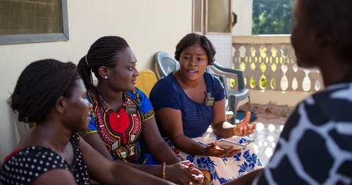 Sister missionaries share gospel with investigators in Ghana.