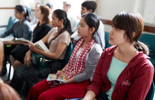 young adults sitting together and learning
