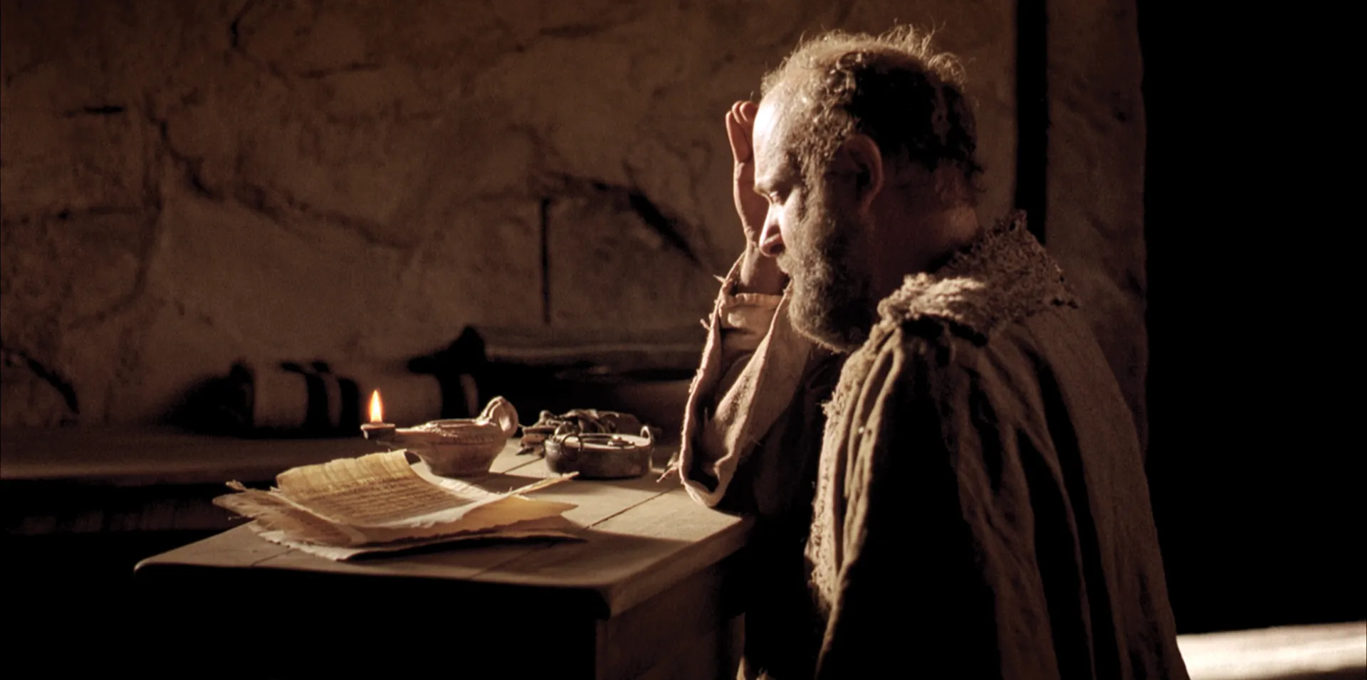 Paul writes and waits as he is about to be executed.