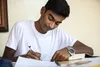 teenager writing on a piece of paper