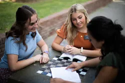 Sister missionaries teach a woman