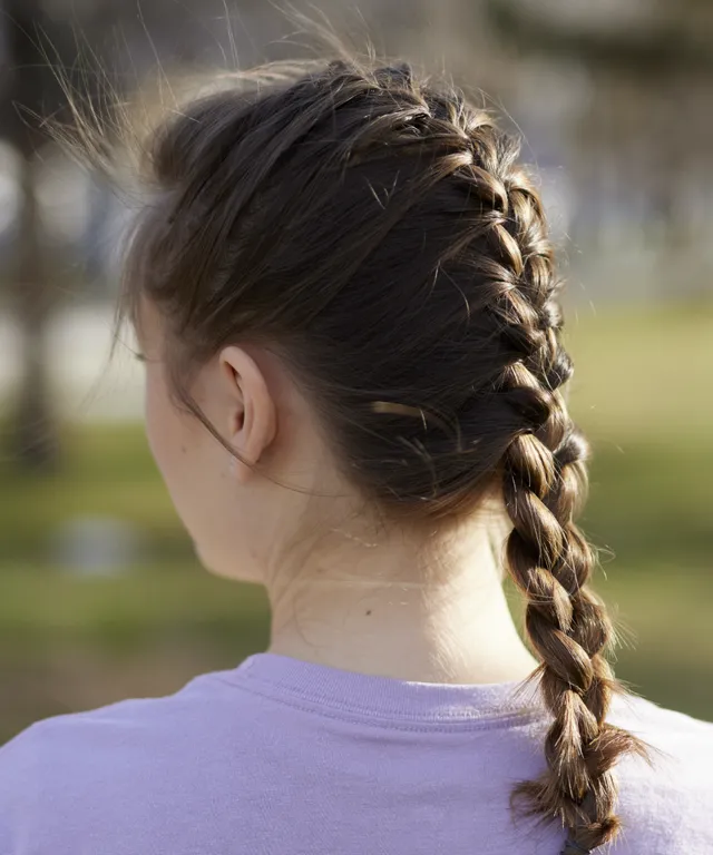 A sister missionaries is outside. She are modeling appropriate exercise clothing during p-day.
