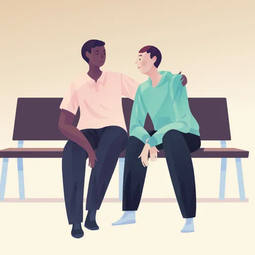 a person sits with another person to comfort them