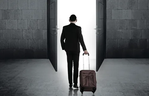 young man walking with suitcase