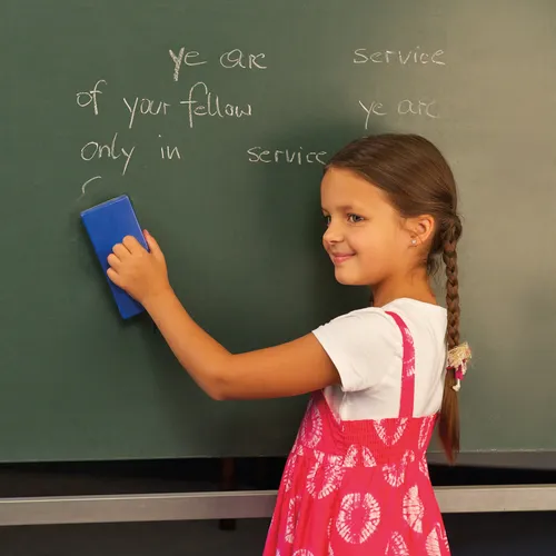 child writing on chalkboard