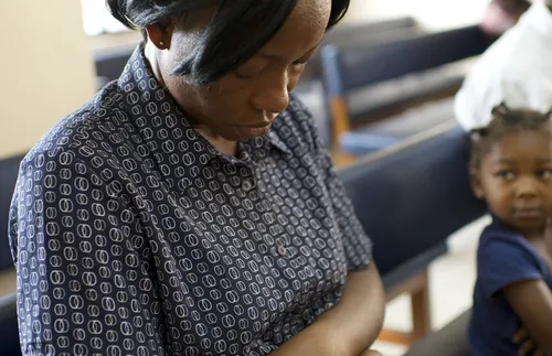 woman with head bowed