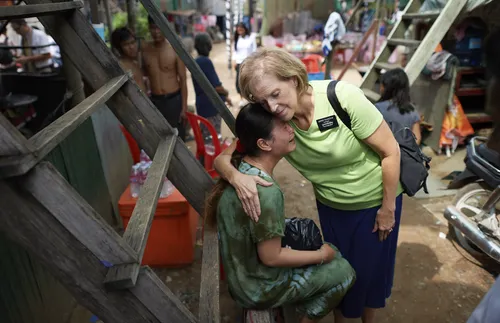 Sister Thurston hugging grieving girl