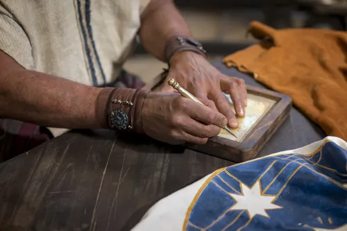 Nephi engraves his testimony on metal plates.