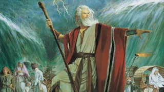 The Old Testament prophet Moses standing with his arm extended toward the Red Sea. Moses is commanding the Red Sea to part to allow the Israelites to escape the Pharoah of Egypt.