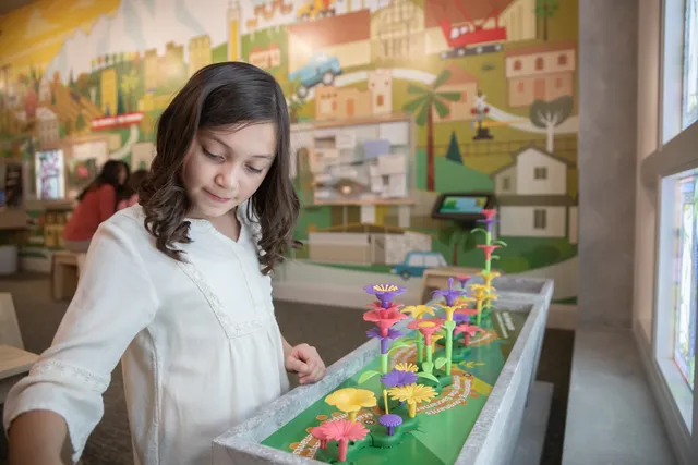 A children's exhibit is set up in the Church History Museum. These images are of areas with interactive elements. A young girl is playing.