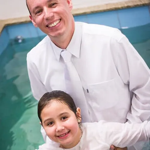young woman being baptized