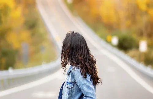 Woman looking down a road