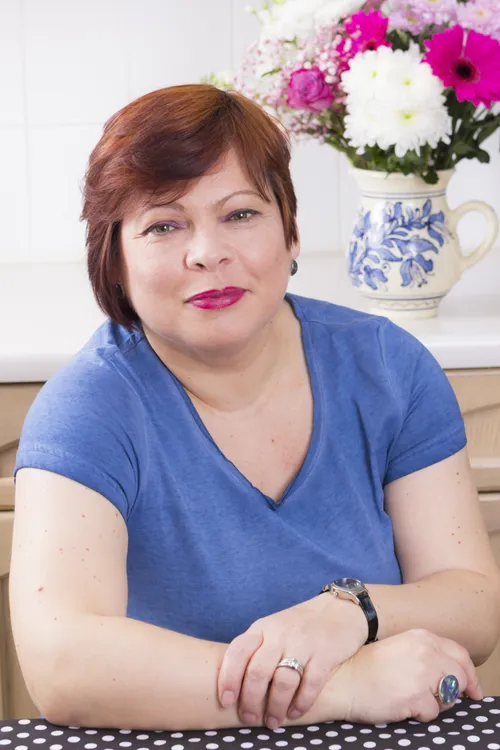 Happy mature woman smiling in kitchen