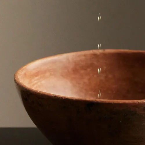 oil dripping into a bowl