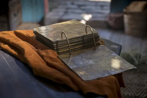 The brass plates sit open on a table.