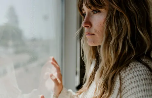 woman staring out a window