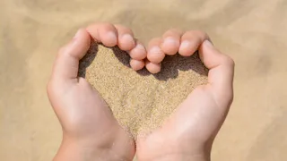 hands holding sand