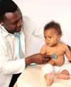 doctor listening to babys heartbeat