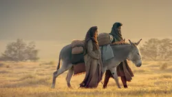 Mary and Joseph with a donkey travel to Bethlehem