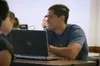 man with computer in class