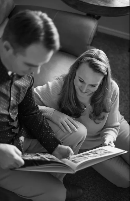 husband and wife looking at a book