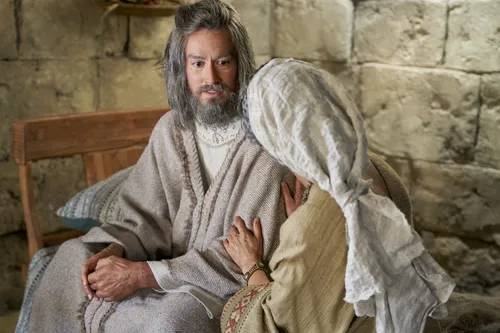 Alma the Elder and his wife sit and talk together.