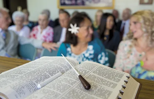 baton lying on open scriptures