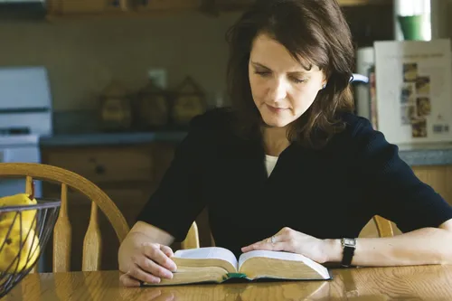 teacher preparing with scriptures and manual