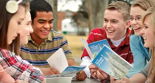 group of youth with booklet
