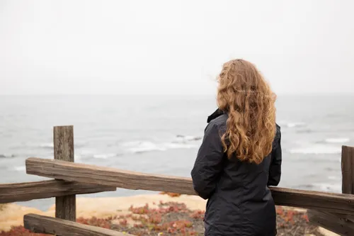 young woman looking out at the ocean
