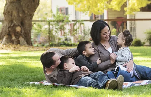 family laying on lawn
