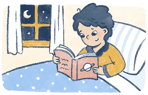 Boy reading a book at bedtime