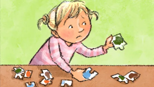 Little girl frowning while doing a puzzle