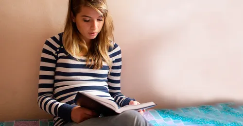 girl reading Book of Mormon
