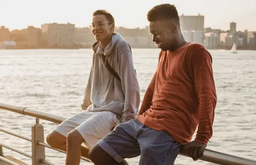 men sitting on a handrail