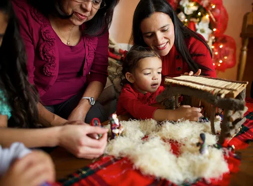 family setting up nativity