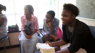 South Africa.  Members attending church on Sunday, young woman listening in Sunday School class.
