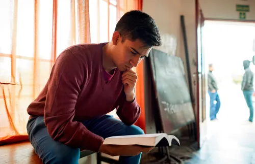 young man reading the scriptures