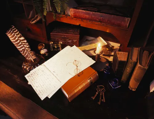 Still life photograph depicting early edition copies of the scriptures and 19th century manuscripts.  Other objects including keys, a pocket watch and a feather pen are lying next to the manuscript pages.